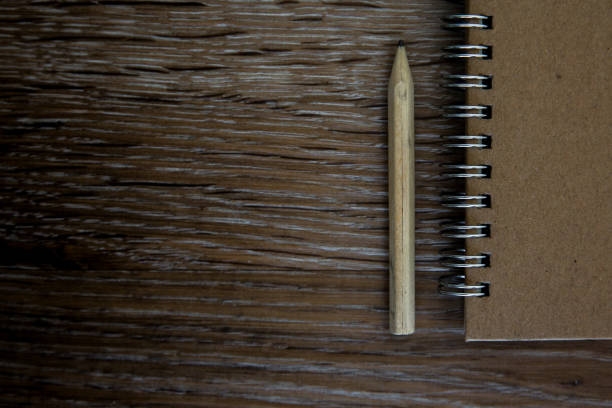 istock An old fashioned desk with pencil and spiral notebook with copy space 1218824907