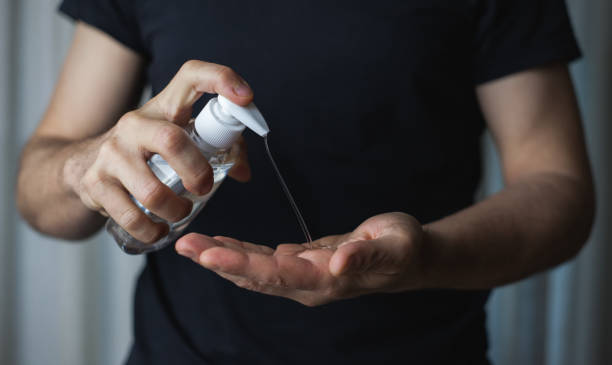 istock Adult man using hand sanitizer gel 1218825794