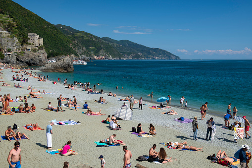 Monterosso al Mare, Italy_May 18, 2018. Tourists enjoying their time on beach at Monterosso al Mare, one of the famous villages in Cinque Terre National Park in La  Spezia northern Italy.