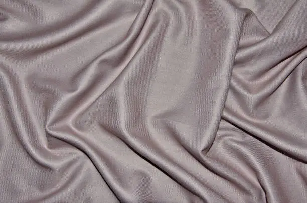 Photo of Pale pink woolen with viscose fabric with soft folds - textile background