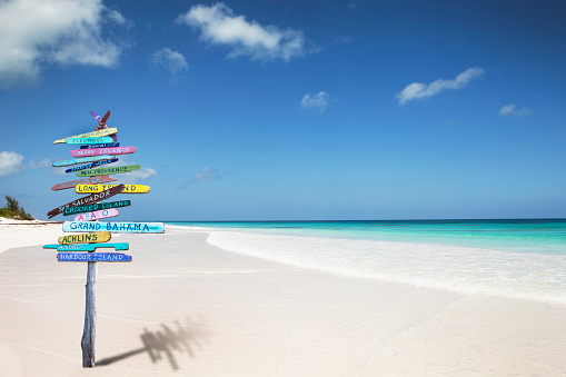 Bahamas beach sign with Bahamas island names on it.