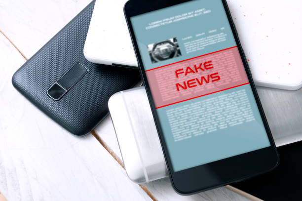 Stack of smartphones with "fake news" alert on the top one. Conception of increasing level of fake news. Stack of smartphones with "fake news" alert on the top one. Conception of increasing level of fake news. falsehood stock pictures, royalty-free photos & images