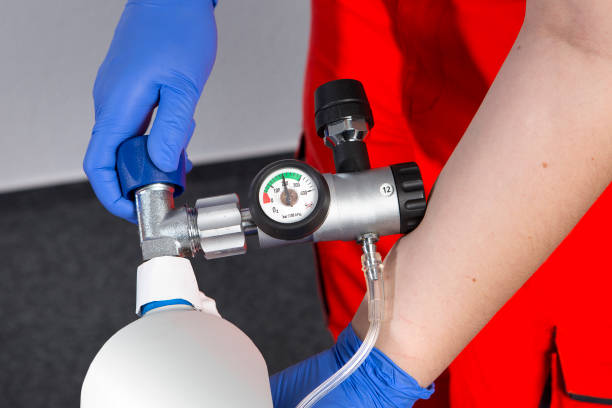 istock First Aid. Opening a 2-liter oxygen tank 1218829428