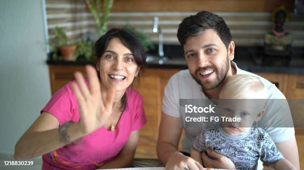 Family Doing A Video Chat At Home Stock Photo - Download Image Now - Webcam, Talking, Discussion