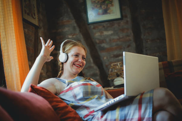 istock Young woman using laptop at home 1218830465