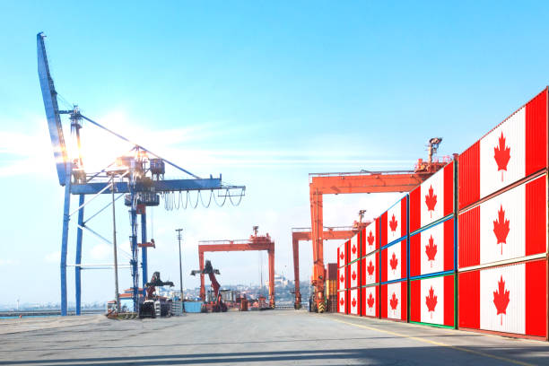 istock The crane is hoisting Shipping cargo containers with CANADA flag 1218830502
