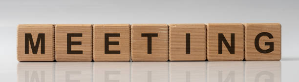 istock MEETING word written on wood cube blocks on white grey glossy background 1218831380