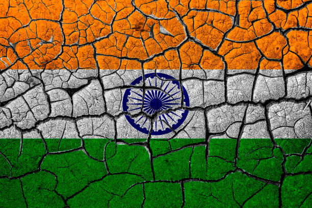 istock India flag on cracked wall, dry ground 1218831446