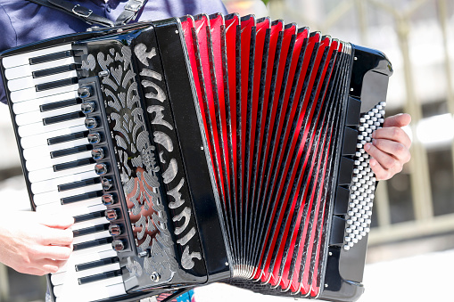 A man playing an accordion on the street in Lisbon.