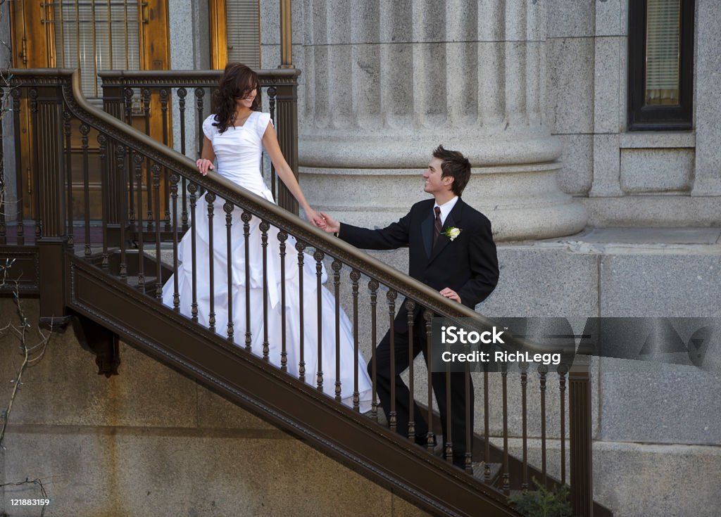 Bride and Groom on Stairs A bride leading the groom upstairs. 20-29 Years Stock Photo