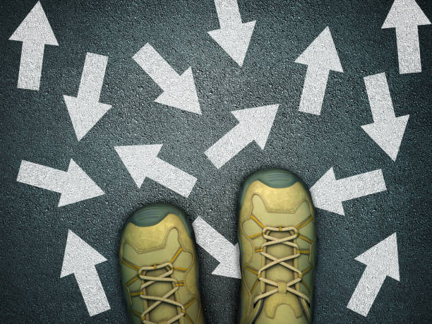 istock Feet on Asphalt Road with Arrows - 3D Rendering 1218831646