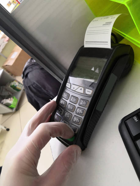 istock Hand in glove and terminal for cashless payment 1218831727
