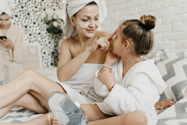 Virtual spa day Mother and her daughter applied facial masks and enjoying at home. home pampering stock pictures, royalty-free photos & images