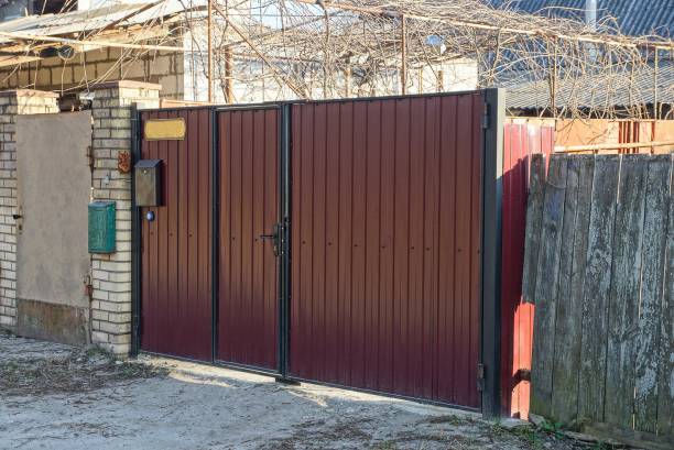 istock big brown metal gate and fence 1218838437