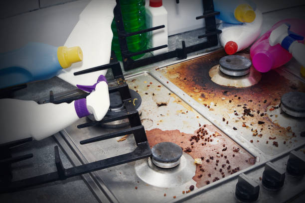 istock dirty kitchen stove, empty and full bottles of detergents around. 1218841135