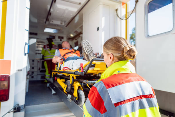 paramedics putting injured man on stretcher in ambulance car - stretcher imagens e fotografias de stock