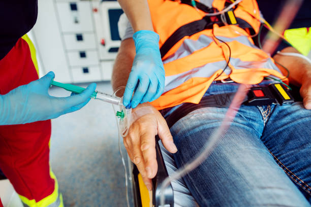 istock Emergency doctor administering injection needle in ambulance 1218841482