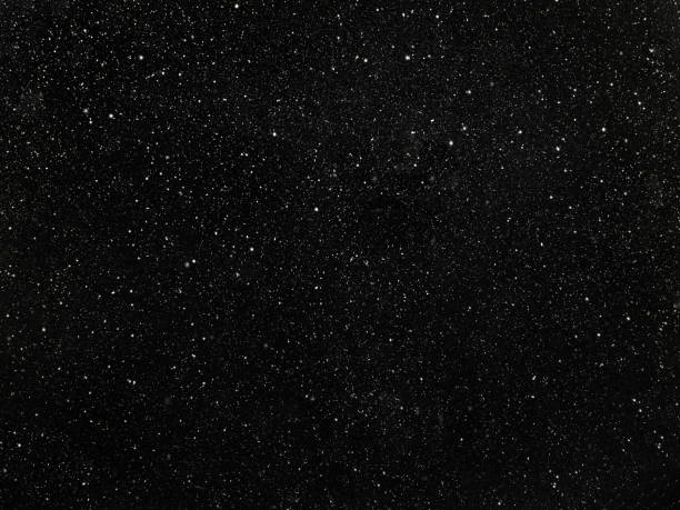 istock Stars in a black sky, abstract black background with white dots 1218841701