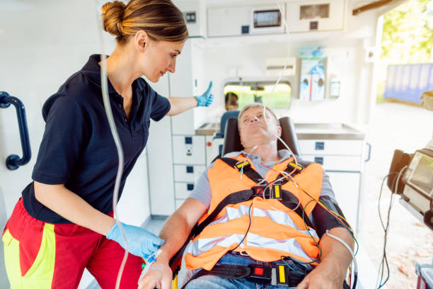 Paramedic in ambulance car giving driver the sign to drive off Paramedic in ambulance car giving driver the sign to drive off with thumbs up car transporter stock pictures, royalty-free photos & images