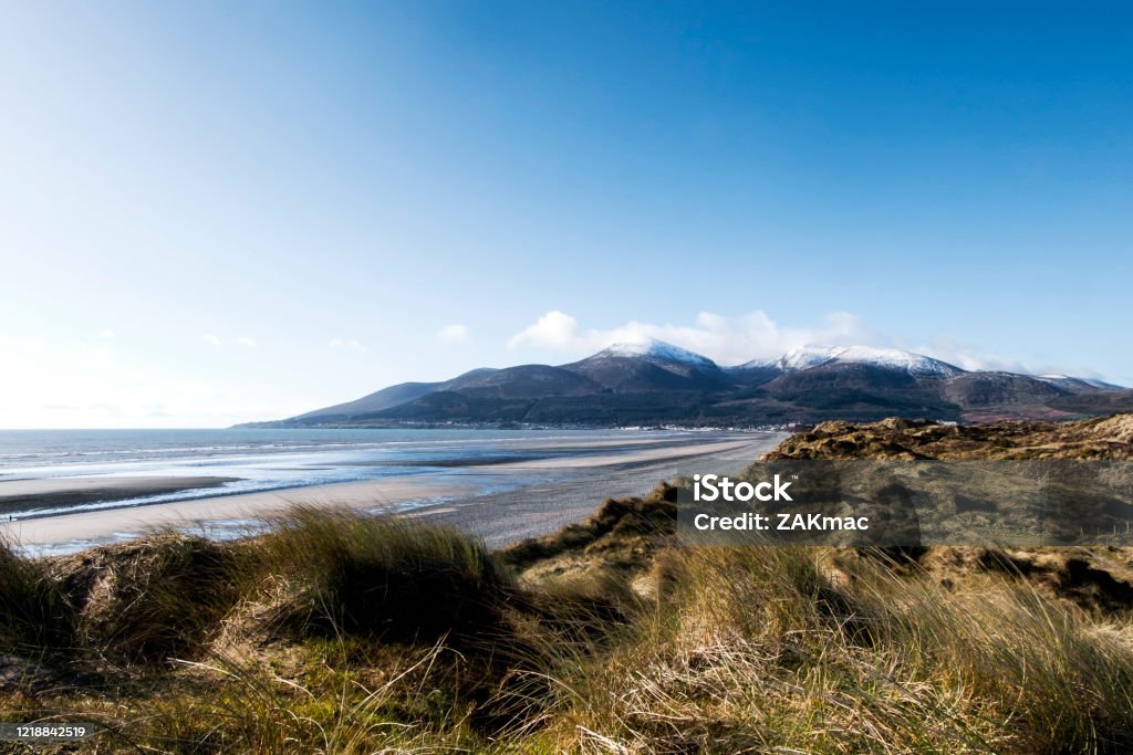 Mourne Mountains, County Down, Northern Ireland The Mourne Mountains, County Down, Northern Ireland. The photograph is taken from Murlough Bay looking towards the town of Newcastle in Northern Ireland. The photograph consists of Mountains, the sea, the beach and sand dunes. Northern Ireland Stock Photo