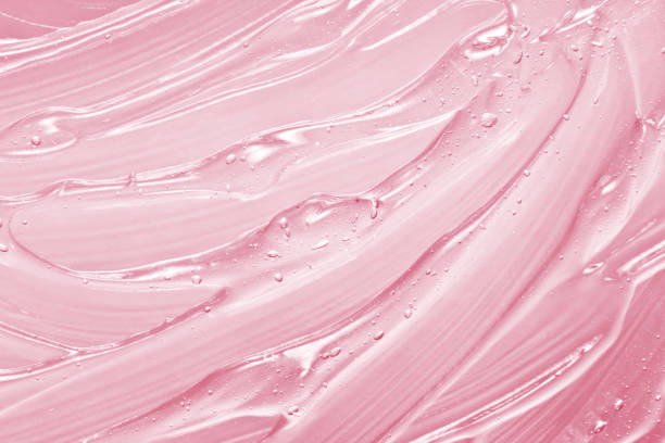 Pink cosmetic gel texture Pink gel texture. Cosmetic clear liquid cream smudge. Transparent skin care product sample close up. Hand sanitizer, alcohol gel background. Beauty product macrophotography amino acid photos stock pictures, royalty-free photos & images