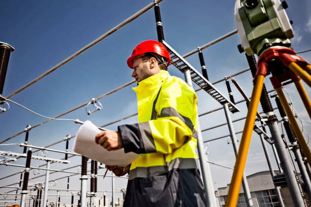istock Engineer at electricity station holding plans blueprint 1218846783