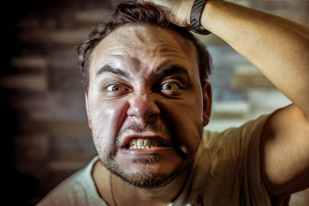 istock An angry man rips his hair. 1218846812