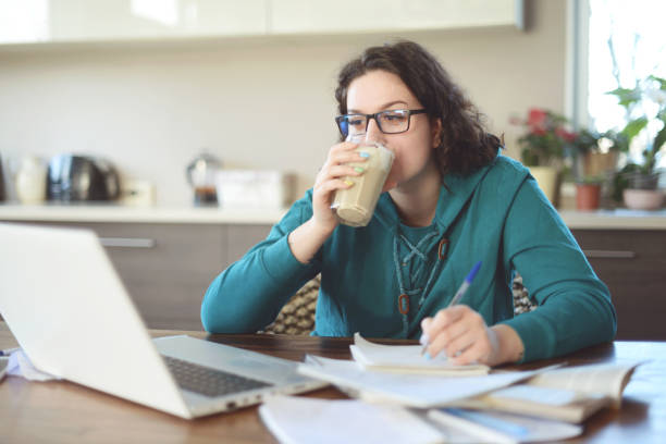 istock Beautiful young woman working at home (eyeglasses) 1218847917