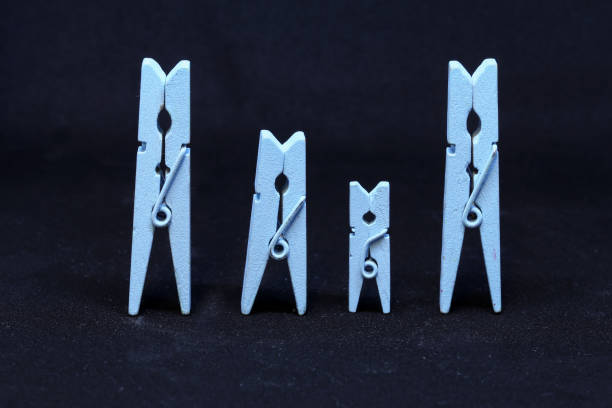 istock Blue wooden clothespins on a black background 1218848834