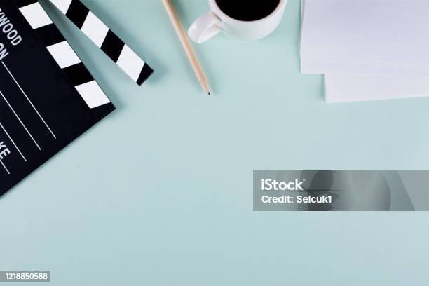 Movie Clapper Board And Coffee Cup On Blue Background With Copy Space Stock Photo - Download Image Now