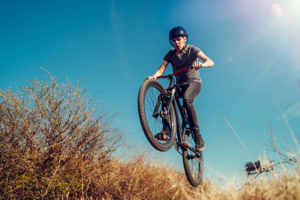 istock Extreme mountain biker jumping and performing aerial maneuvers 1218851345