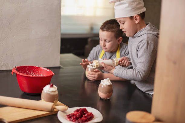 istock Two boys, brothers, preparing dessert at home 1218851462