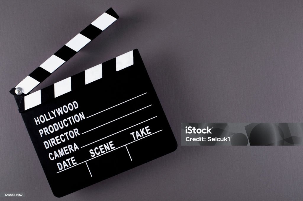 Movie clapper board on dark background with copy space. Oscar Statuette Stock Photo