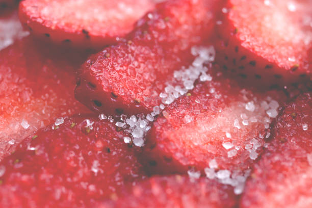 Fresh vitamin berry backdrop. Sliced strawberry in sugar filling background. Red healthy tasty strawberry with sugar texture.