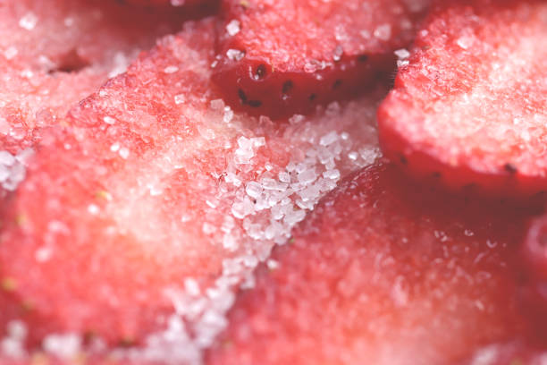 Sliced strawberry in sugar filling background. Red healthy tasty strawberry with sugar texture. Fresh vitamin berry backdrop.