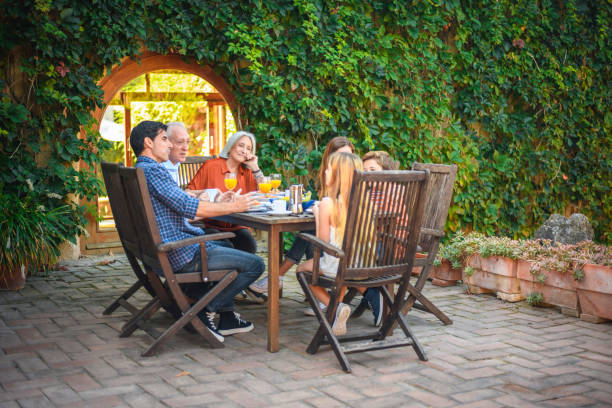 istock Relaxed Spanish Family Conversing During Outdoor Breakfast 1218852630