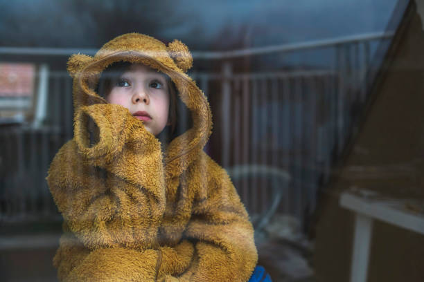 Sad child in isolation at home stock photo