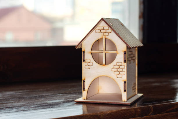 istock Stay at home. Wooden house on a dark background 1218856868