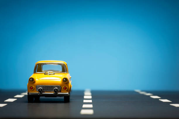 istock Yellow toy car on a blue background. 1218857653