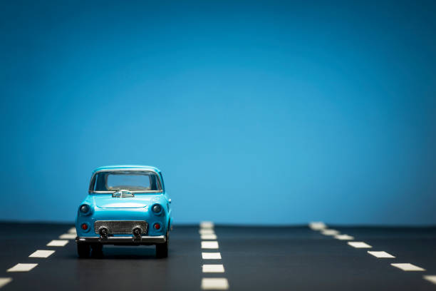 istock Blue toy car on an asphalt road. 1218857663