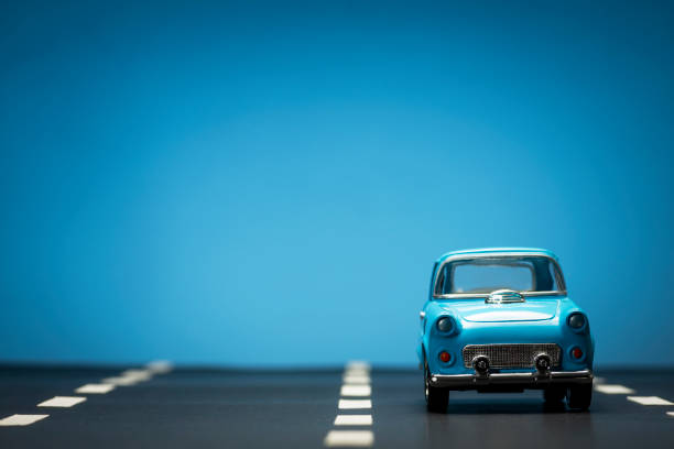 istock Blue toy car on an asphalt road. 1218857664