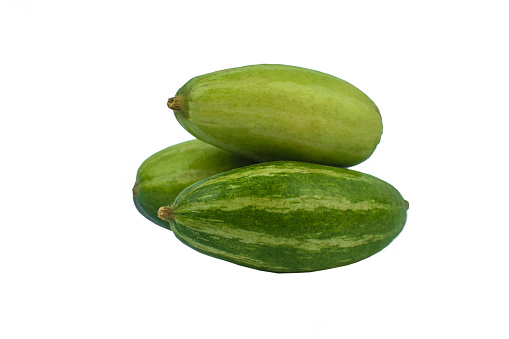 Three fresh green colored pointed gourd stacked on an empty white background