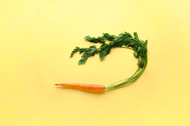 istock Flat lay composition with ripe fresh carrot on yellow background 1218858084