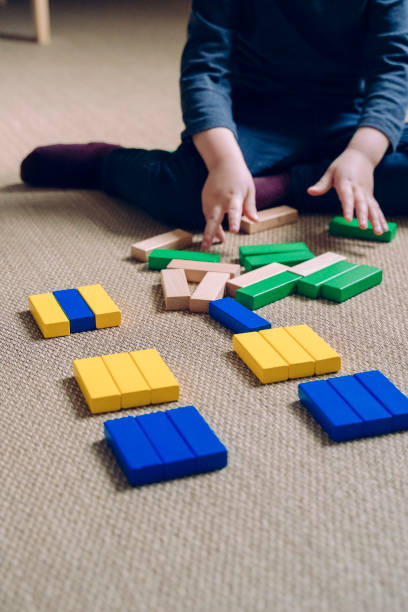 istock Unrecognizable little boy playing at home with educational game for children. 1218858321
