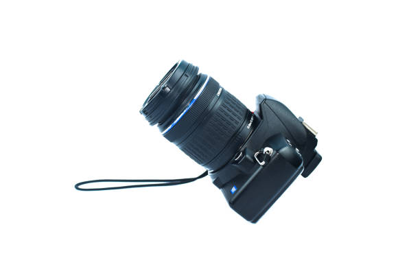 istock Single digital camera of black color with lens attached to it placed on a white isolated background 1218861738