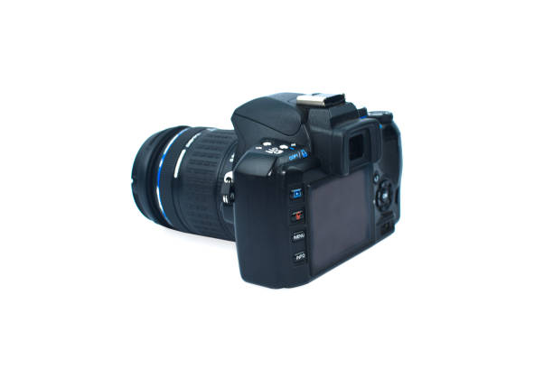 istock Single black colored digital camera with a nice lens attached to it on top of white isolated background 1218861752