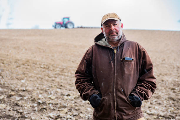 istock A mature farmer standing in a field with sleet falling 1218861887