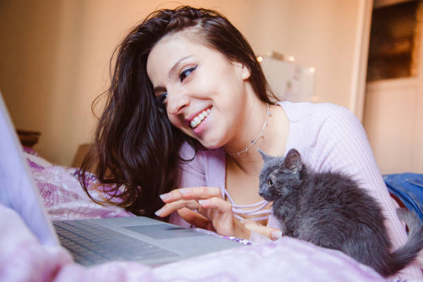 istock Beautiful young woman staying home connected to internet with computer. 1218862477