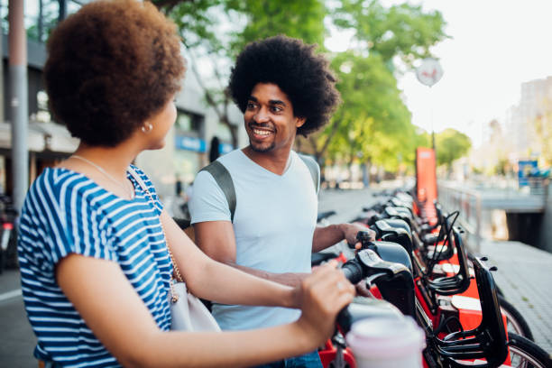 istock Couple sitting on rent a bikes and talking 1218865362