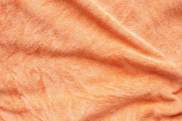 istock Orange towel fabric texture surface close up background 1218866572
